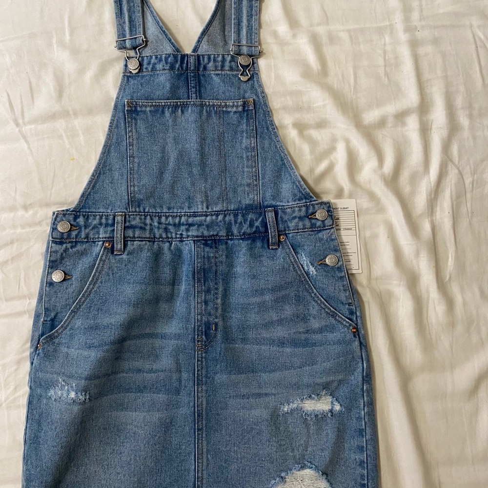 Ripped overall denim dress.